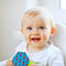 Baby enjoying food from a Squooshi robots/bikes pouch with Filling Station.