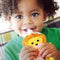 Child enjoying food from a Squooshi lion-themed reusable pouch.